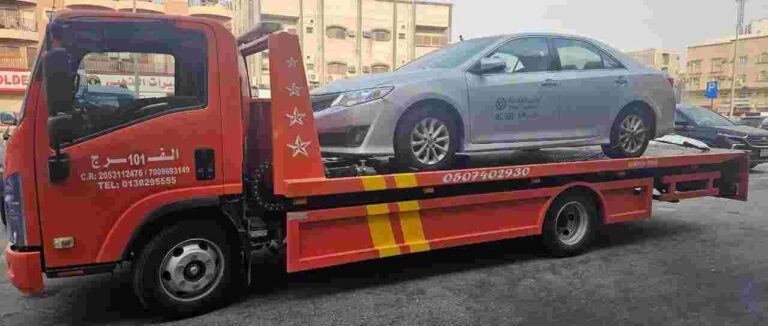 Al-Faraj 24/7 emergency towing truck recovering a car on a highway in Al Khobar